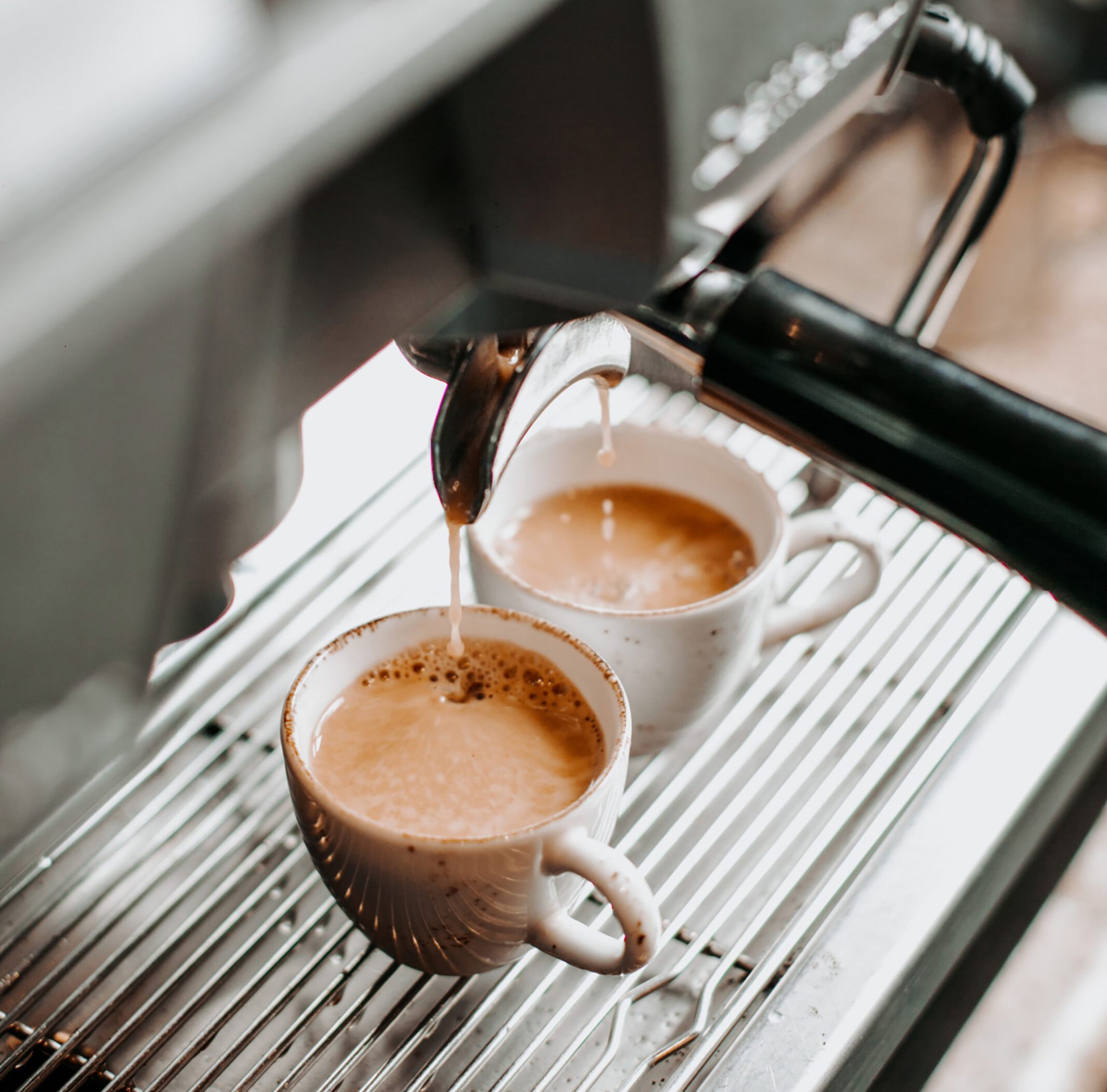 two espresso cups under coffee engine _